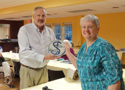 A man and woman holding an object. 